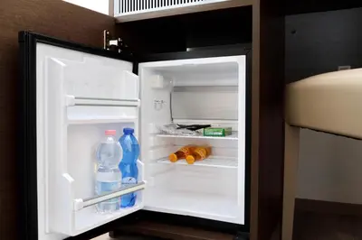 an open refrigerator with bottles of water and food at Victory Rooms in Rome
