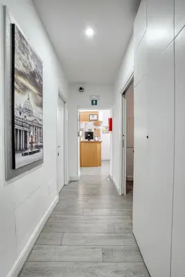 an empty hallway with white walls and a painting on the wall at Rhome Guest House in Rome