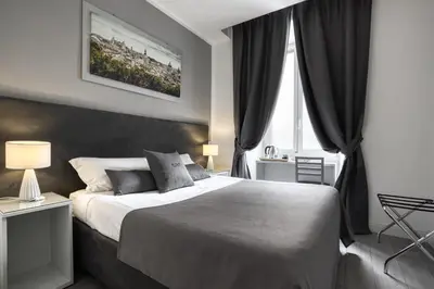 a bedroom with a large bed and a window at Rhome Guest House in Rome