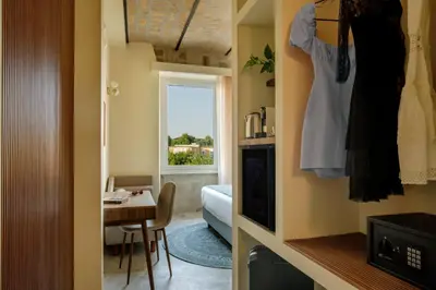 a small room with a bedroom and a room with a table at Rome for Two in Rome