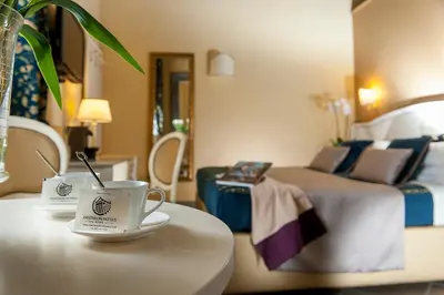 a hotel room with a bed and a cup of coffee on a table at Dimora Degli Dei in Rome