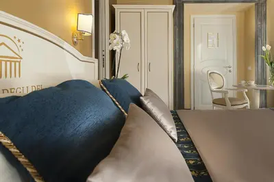a bedroom with a bed with blue pillows at Dimora Degli Dei in Rome