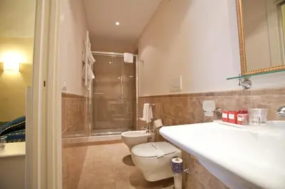 a bathroom with a toilet and a sink and a shower at Dimora Degli Dei in Rome