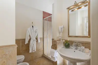 a bathroom with a sink and a toilet and a mirror at Dimora Degli Dei in Rome