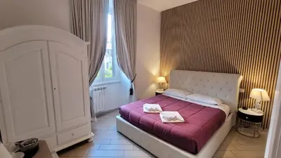 a bedroom with a bed with two towels on it at Rome Central Rooms in Rome