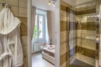 a bathroom with a walk in shower and a sink at Rome Central Rooms in Rome