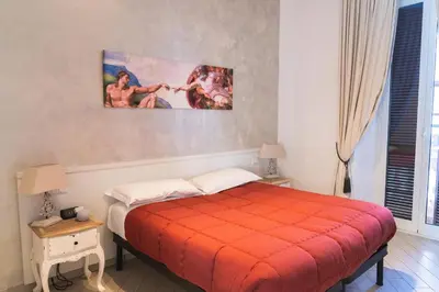 a bedroom with a bed with an orange blanket at Rome Central Rooms in Rome