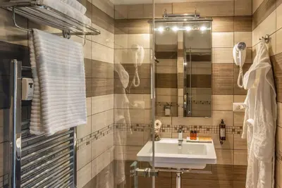 a bathroom with a sink and a mirror at Rome Central Rooms in Rome