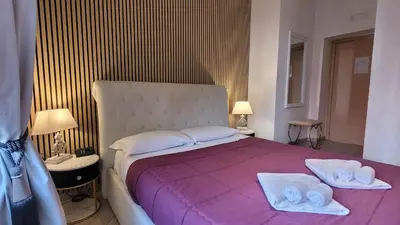 a bedroom with a large bed with towels on it at Rome Central Rooms in Rome