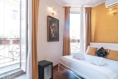 a hotel room with a bed and a balcony at Golden Rooms Piazza di Spagna in Rome