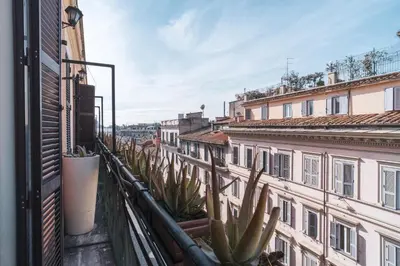 a view from a balcony of buildings with cactus at Golden Rooms Piazza di Spagna in Rome