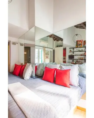 a bedroom with a large bed with red pillows at PantheonDreamSuite in Rome