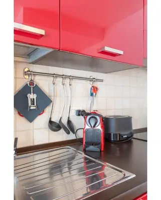 a kitchen with a counter with a sink and utensils at PantheonDreamSuite in Rome