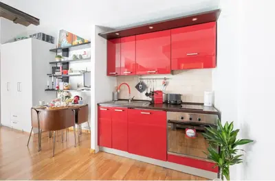 a kitchen with red cabinets and a table at PantheonDreamSuite in Rome