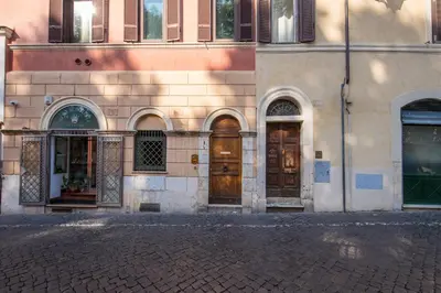 a building with doors and windows on a street at Campo di Fiori 2 bedroom Via Giulia in Rome