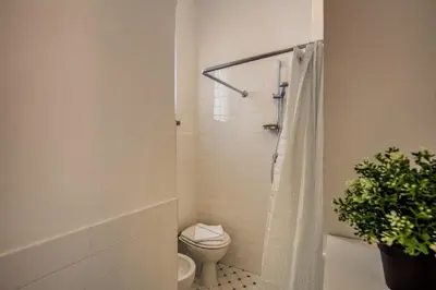a bathroom with a toilet and a shower with a plant at Campo di Fiori 2 bedroom Via Giulia in Rome