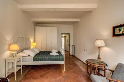a bedroom with a bed and a table and a chair at Campo di Fiori 2 bedroom Via Giulia in Rome