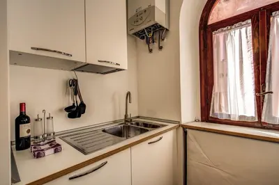 a small kitchen with a sink and a window at Campo di Fiori 2 bedroom Via Giulia in Rome