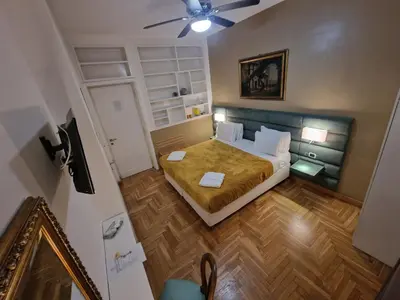 a dining room with tables and chairs in a room at Sweet Home Parioli in Rome