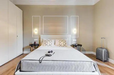 a bedroom with a large bed and a suitcase at Repubblica Exclusive Apartment in Rome