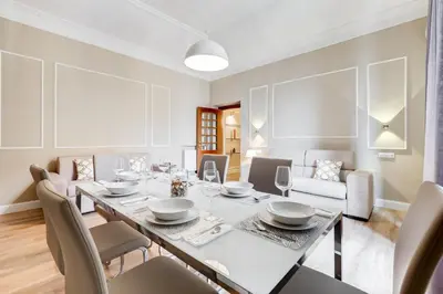 a dining room with a table and chairs at Repubblica Exclusive Apartment in Rome