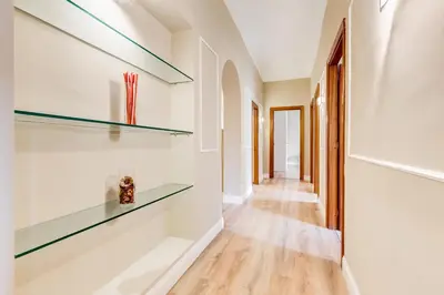 a hallway with glass shelves on the wall at Repubblica Exclusive Apartment in Rome