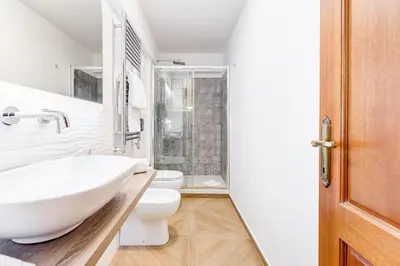 a bathroom with a white sink and a toilet at Repubblica Exclusive Apartment in Rome