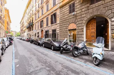 a row of parked scooters and cars parked on a street at Repubblica Exclusive Apartment in Rome