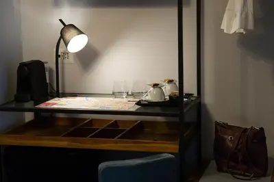 a desk with a lamp and glasses on it at Lungotevere Ripa in Rome