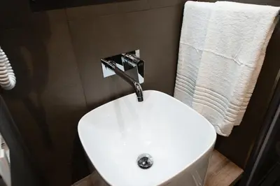 a white sink with a faucet in a bathroom at Lungotevere Ripa in Rome