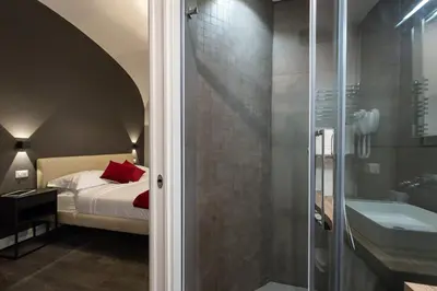 a bedroom with a bed and a glass shower at Lungotevere Ripa in Rome