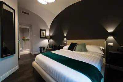 a bedroom with a large bed with a black wall at Lungotevere Ripa in Rome