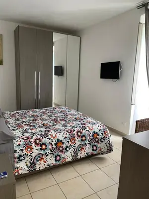 a bedroom with a bed with a floral comforter at Appiolatino - Il Fenicottero in Rome