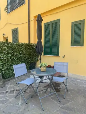 a table and two chairs and an umbrella at Appiolatino - Il Fenicottero in Rome