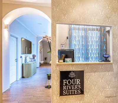 a bedroom with a large white bed and a window at Four Rivers Suites in Rome