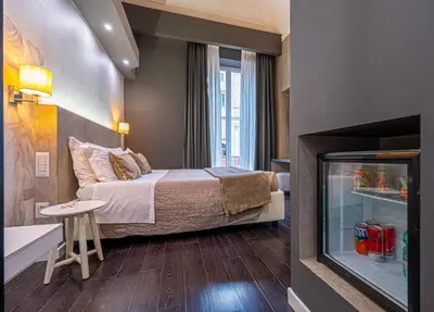 a bedroom with a large bed and a glass shower at Four Rivers Suites in Rome