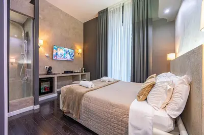 a bedroom with a large bed and a window at Four Rivers Suites in Rome