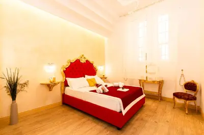 a bedroom with a large red bed in a room at Roma Charming Rooms in Rome