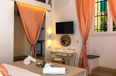a bedroom with a bed and a tv and a window at Roma Charming Rooms in Rome