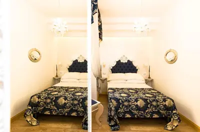 a bedroom with two beds and a flag at Roma Charming Rooms in Rome