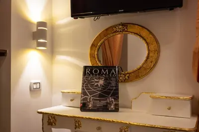 a book sitting on a table next to a mirror at Roma Charming Rooms in Rome