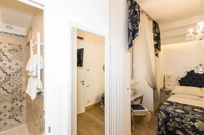 a bedroom with a bed and a mirror at Roma Charming Rooms in Rome
