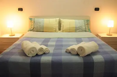 a bed with three rolled towels on top of it at Hello Roma B&B in Rome