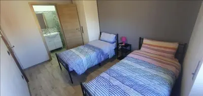 a bedroom with two beds and a sink and a mirror at Hello Roma B&B in Rome