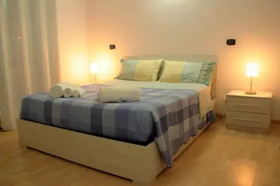 a bedroom with a bed with two towels on it at Hello Roma B&B in Rome