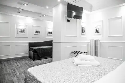 a living room with a bed and a couch at Locanda Parlamento in Rome