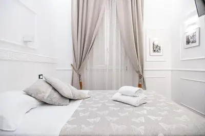 a bedroom with a bed with two towels on it at Locanda Parlamento in Rome