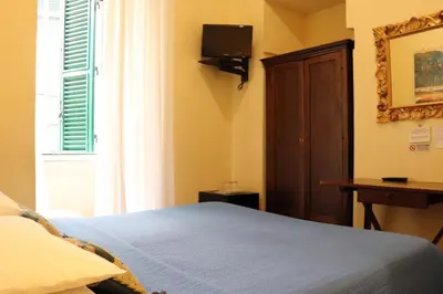 a bedroom with a bed and a tv on the wall at The Center Of Rome B&B in Rome