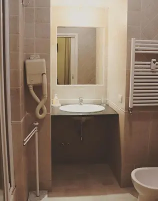 a bathroom with a sink and a mirror at The Center Of Rome B&B in Rome