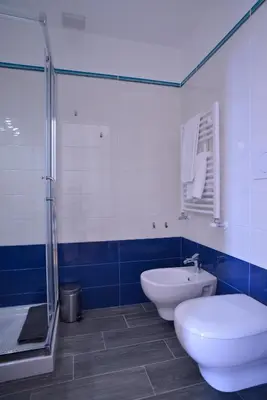 a bathroom with a toilet and a sink and a shower at Livia B&B - Trastevere in Rome